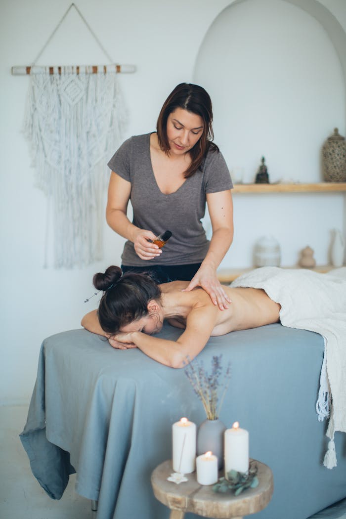 A serene spa massage with candles and essentials fostering relaxation and wellness.